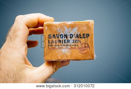 Paris, France - Jun 27, 2019: Man Hand Holding New Bio Organic Savon Dalep With 30 Percent Laurel Al