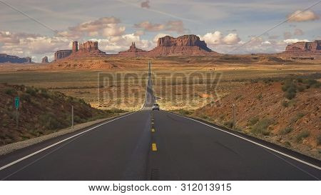 Silver Car On Highway 163 At Monument Valley