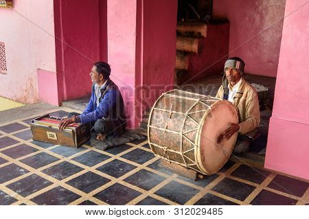 Deshnok, India - February 11, 2019: Indian Men Playing The Drum And Harmonium In Karni Mata Temple O