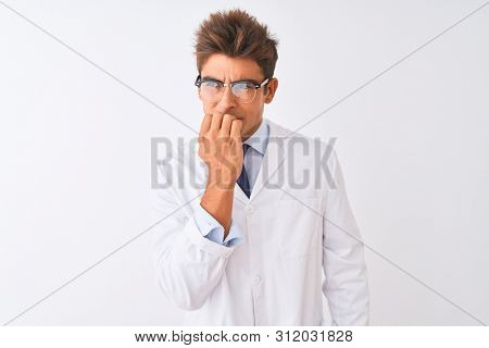 Young handsome sciencist man wearing glasses and coat over isolated white background looking stressed and nervous with hands on mouth biting nails. Anxiety problem.