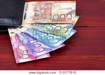 Kenyan Shillings In The Black Wallet On A Wooden Background