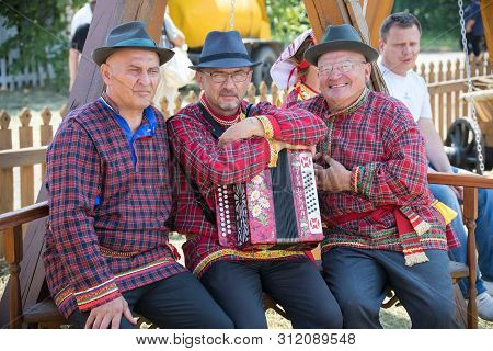 Republic Of Tatarstan, Russia: 04.07.2019 - Old Men In Traditional Tatar Clothes Are Siting On The B