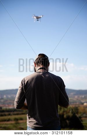 Man Playing With Drone On The Open Field