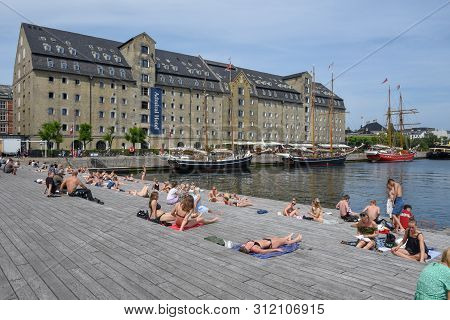 People Sunbathing In The Center Of Copenhagen On Denmark