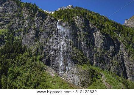 Mountain River Stream, Waterfall In The Mountains, Mountain Creek Among Pines. Cascade Falls Over Gr