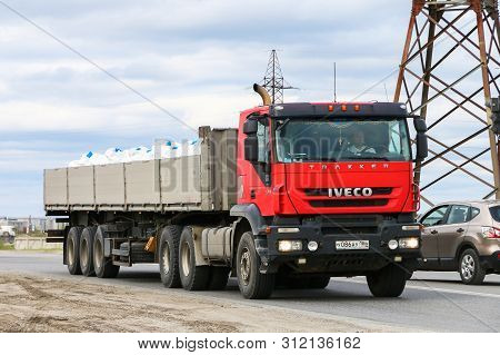 Novyy Urengoy, Russia - June 25, 2019: Red Semi-trailer Truck Iveco Trakker In The City Street.