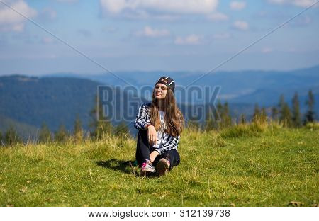 Successful Woman In Cap On Top Of Hill Enjoy View On Mountain Peak