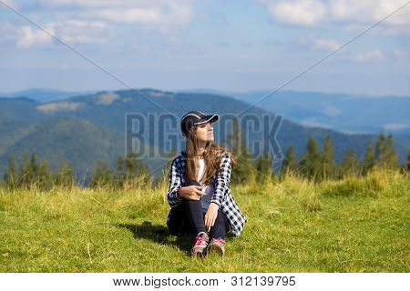 Successful Woman In Cap On Top Of Hill Enjoy View On Mountain Peak