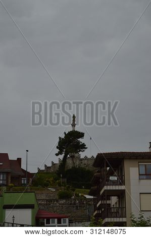 Monument To The Marques De Comillas On A Cloudy Day In Comillas. August 26, 2013. Comillas, Cantabri