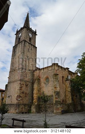 Church Of San Cristobal Located In The Center Of The Villa On A Cloudy Day In Comillas. August 26, 2