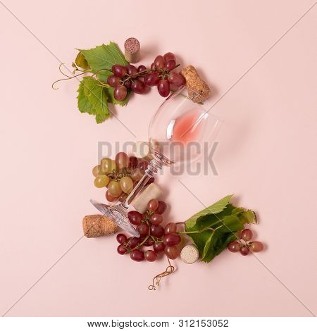 Alphabet. Letter Z Made Of Wineglasses With Rose And White Wine, Grapes, Leaves And Corks Lying On P