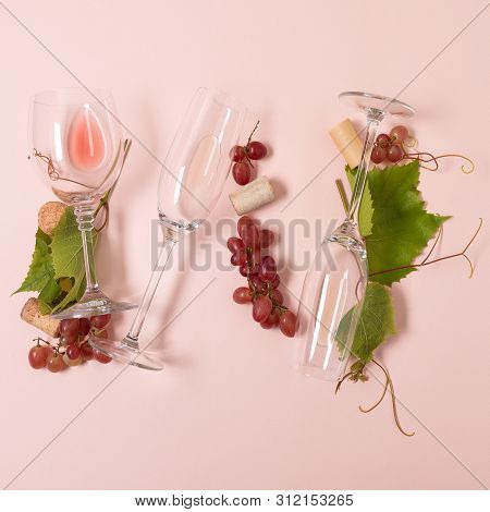 Alphabet. Letter W Made Of Wineglasses With Rose And White Wine, Grapes, Leaves And Corks Lying On P