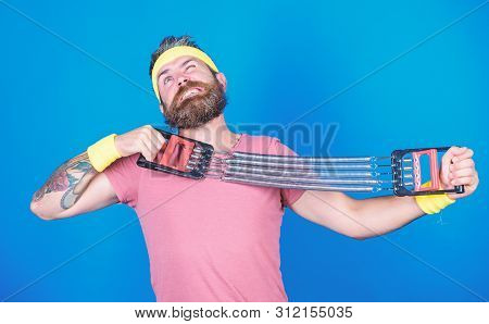 Sportsman Stretching Expander. Try Stretching Exercise. Athlete Workout With Expander. Improve Your 