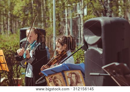 Russia, Siberia, Novokuznetsk - May 9, 2019: Musicians Sing Songs On The Street On Victory Day