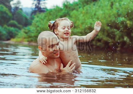 Happy Family Father And Son. Dad Teaches His Son To Swim