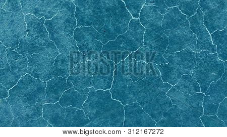 Beautiful Dark Blue Background. Light Cracks On The Surface. Texture Of Old Paint. 