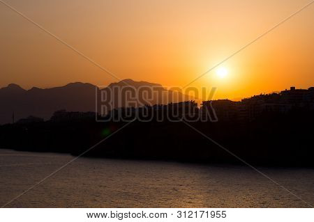 Mountains In A Blue Haze And Sunset Over The Sea. Turkey, Antalya.