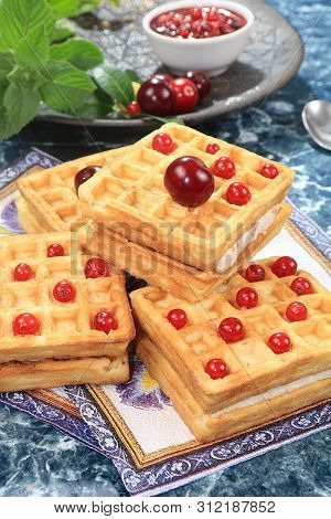Crispy Waffles With Berries On A Sunny Table. Morning Breakfast With Waffles, Currants And Milk On A
