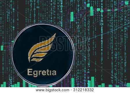 Token Egt Egretia  Cryptocurrency On The Green Matrix Background Of Binary Crypto Price Chart.