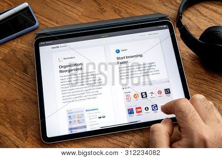 Paris, France - Jun 6, 2019: Man Reading On Apple Ipad Pro Tablet About Latest Announcement Of At Ap