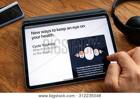 Paris, France - Jun 6, 2019: Man Reading On Apple Ipad Pro Tablet About Latest Announcement Of At Ap