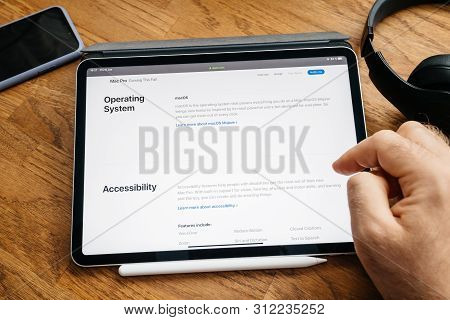 Paris, France - Jun 6, 2019: Man Reading On Apple Ipad Pro Tablet About Latest Announcement Of At De