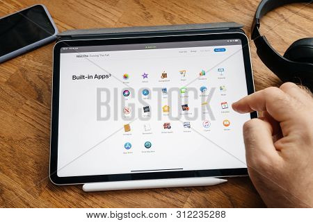 Paris, France - Jun 6, 2019: Man Reading On Apple Ipad Pro Tablet About Latest Announcement Of At De