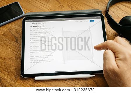 Paris, France - Jun 6, 2019: Man Reading On Apple Ipad Pro Tablet About Latest Announcement Of At De