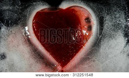 Red Heart In Ice Melting, Looks Like It Is Bleeding. Love - Leaving.