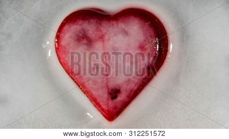Red Heart In Ice Melting, Looks Like It Is Bleeding. Love - Leaving.
