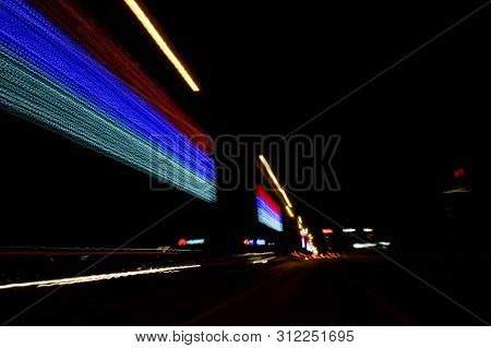 A View Through The Windshield While Driving At Night. Long Exposure. Artistic, Abstract.