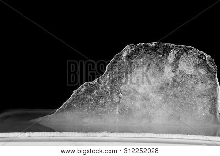 Ice Melting High Contrast, Black Background. Bubbles In Ice.