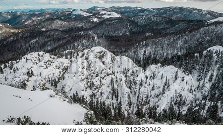 Landscape View Of A Mountain And Dark Forest On The Velebit Mountain.view From The Top. Winter In Ve