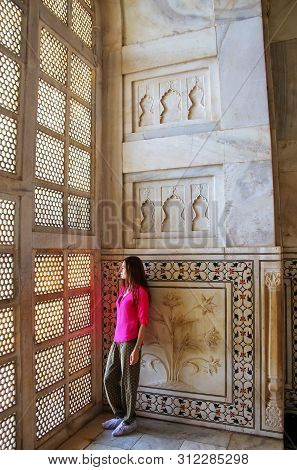 Young Woman Standing By Lattice Jali Screen Inside Taj Mahal, Agra, Uttar Pradesh, India. It Was Bui