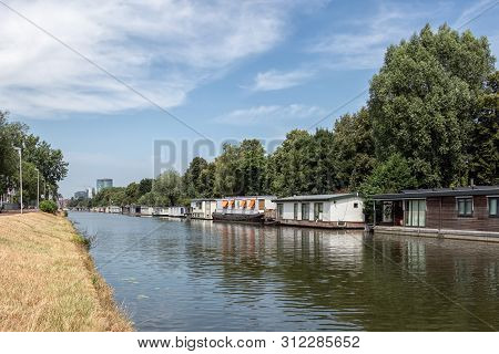 Dutch Canal In City Utrecht With Several Moored Houseboats