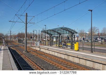 Utrecht, The Netherlands - February 26, 2019: Tram Station With With Waiting Woman In Nieuwegein