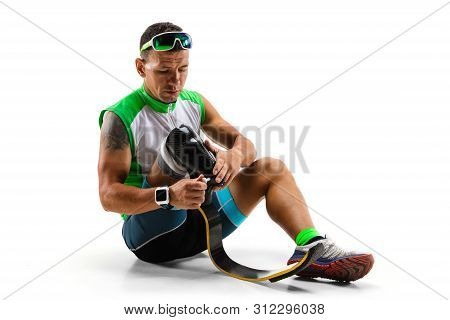 Athlete With Disabilities Or Amputee Isolated On White Studio Background. Professional Male Runner W