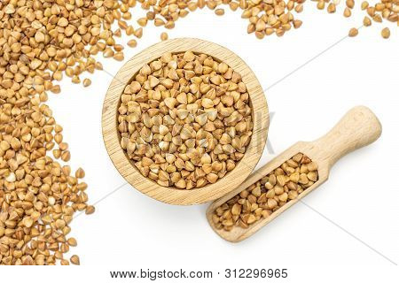 Lot Of Whole Raw Brown Buckwheat Grain In A Wooden Bowl With Wooden Scoop Flatlay Isolated On White 
