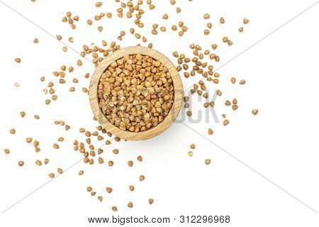 Lot Of Whole Raw Brown Buckwheat Grain In A Wooden Bowl Flatlay Isolated On White Background