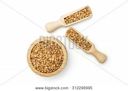 Lot Of Whole Hulled Raw Brown Buckwheat Grain In A Wooden Bowl With Wooden Scoop Flatlay Isolated On