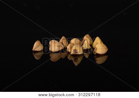 Lot Of Whole Raw Brown Buckwheat Grain Isolated On Black Glass