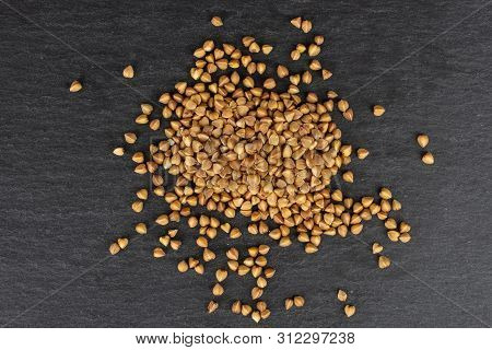 Lot Of Whole Raw Brown Buckwheat Grain Heap Flatlay On Grey Stone