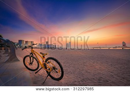 Abudhabi, Uae- 01 January 2019: A Orange Color Bicycle Is Parking In The Corniche Beach Abudhabi