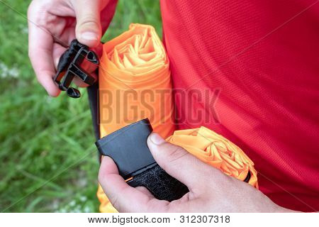 Mens Hands Fasten Or Unfasten A Semi-automatic Fastener For Connecting Fabric Tapes, Lines, Belts. F