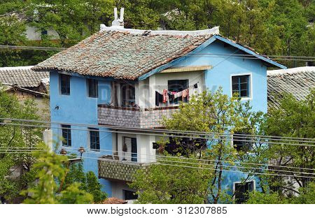 Wonsan, North Korea - May 5, 2019: A Typical Apartment House In Outskirt Of Wonsan. All Housing For 