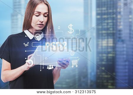 Serious Blonde Woman In Black Dress Using Tablet Computer In Blurred City With Double Exposure Of On