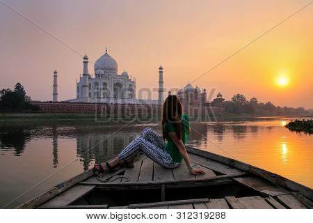 Woman Watching Sunset Over Taj Mahal From A Boat, Agra, India. It Was Build In 1632 By Emperor Shah 