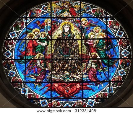 FLORENCE, ITALY - JANUARY 09, 2019: Virgin Mary surrounded by Angels by Lorenzo Ghiberti, stained glass in the Cattedrale di Santa Maria del Fiore (Cathedral of Saint Mary of the Flower), Florence
