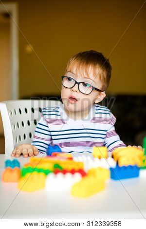 Little Ginger Boy With Glasses With Syndrome Dawn Playing
