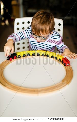 Little Ginger Boy With Glasses With Syndrome Dawn Playing